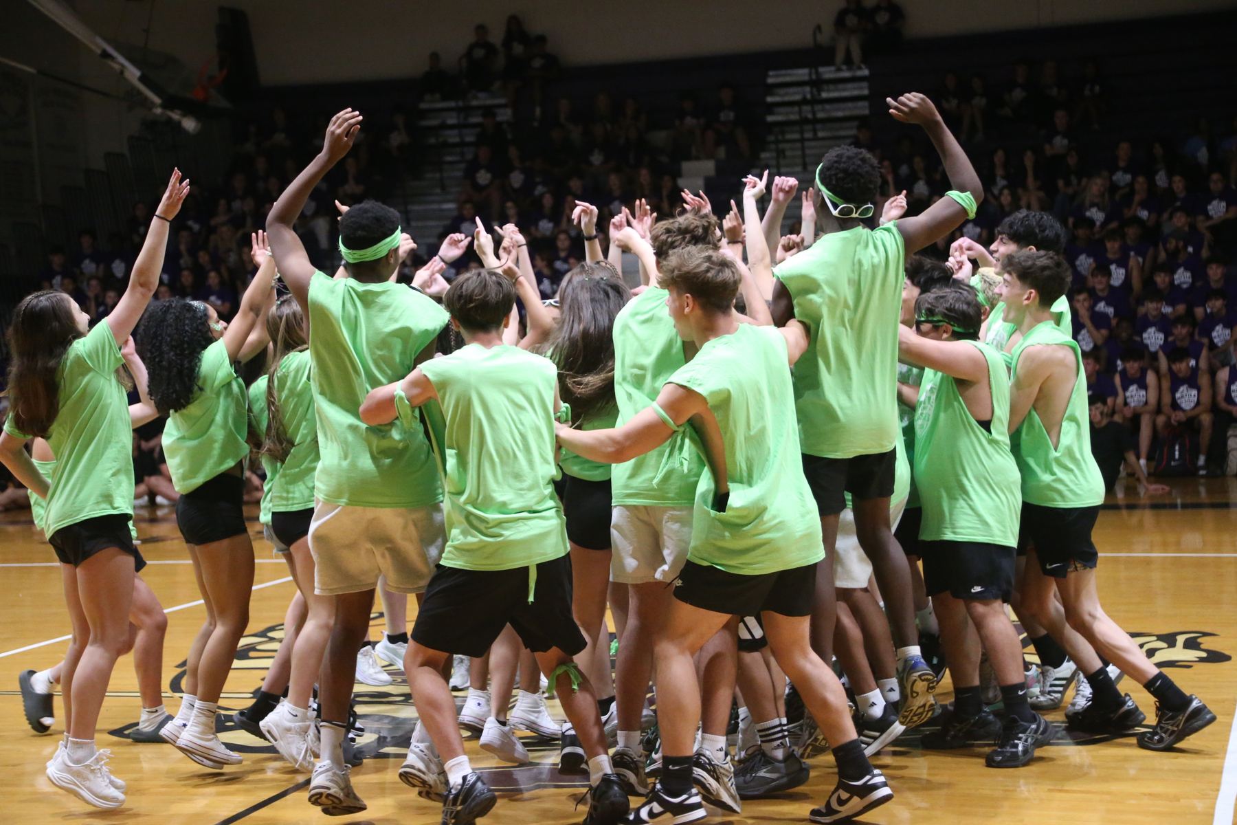 Sophomores huddled on the gym floor at Battle of the Classes